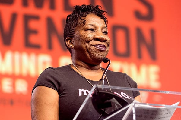 Tarana Burke speaking at a podium via BET