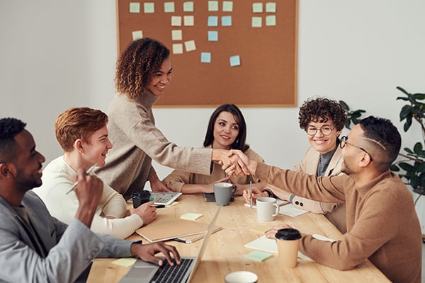 A group of people in a meeting via Pexels.