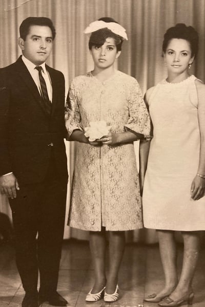 Claudia's mother (middle) at her quincenera with her godparents.