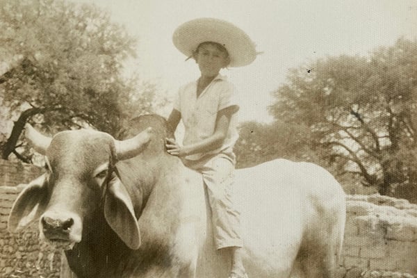 Claudia's father at 8 years old in Mexico, riding a Zebu Bull.