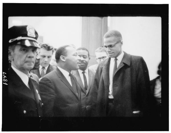 Dr. Martin Luther King, Jr. and Malcolm X waiting for press conference.