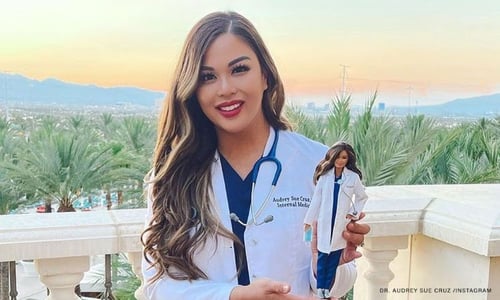 Photo of Dr. Audrey Sue Cruz holding a Barbie doll of her as a Covid-19 pandemic hero