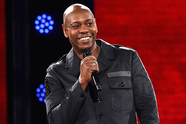 Dave Chappelle performing on stage via People Magazine